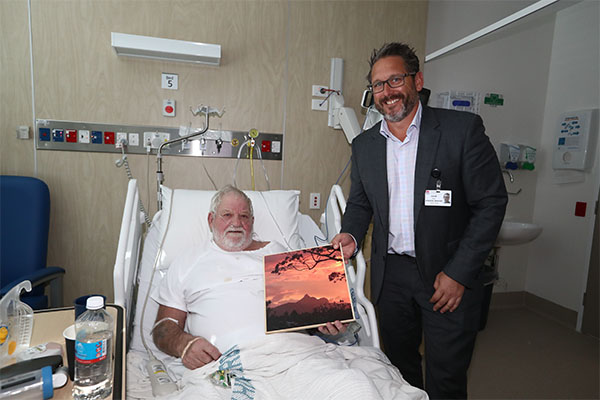 First patient, Wayne Ambrose receives a painting as a gift from TVH A/GM Adam Reid