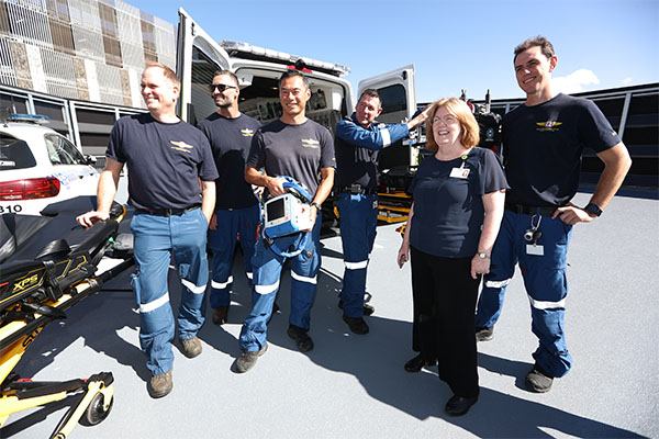 Ambulance and retrieval personnel with NNSWLHD Chief Executive Tracey Maisey