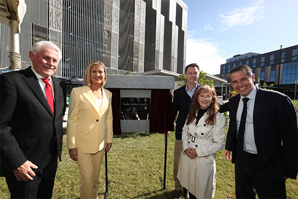 Dignitaries celebrate unveiling the commemorative plaque at official opening of TVH